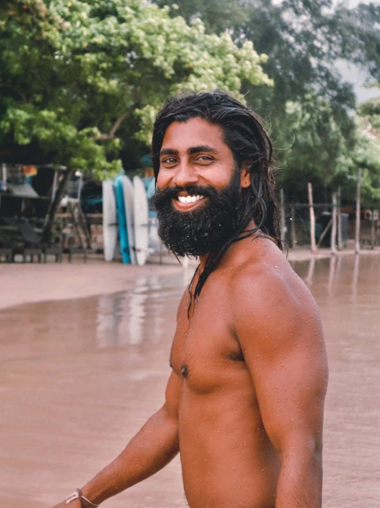 Lahiru Pathum smiling on Weligama beach
